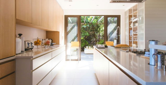 white wooden kitchen island and cupboard cabinets near glass panel door
